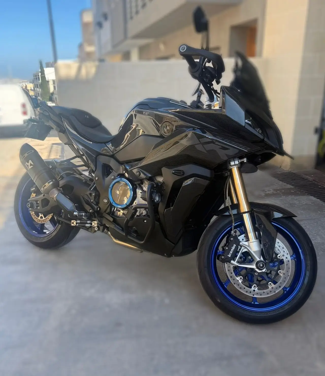 Dark performance motorcycle with blue wheel details